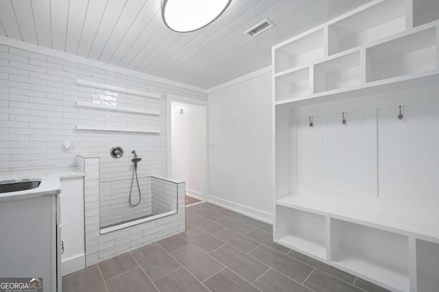 mudroom featuring visible vents, dark tile patterned flooring, and wooden ceiling