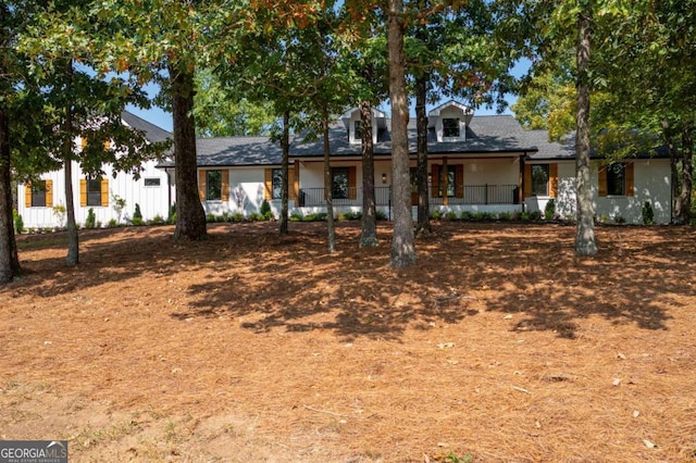 view of front of property with roof with shingles