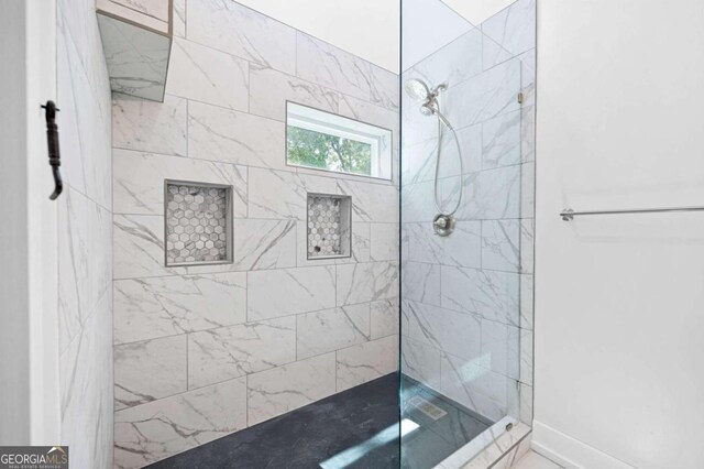 full bathroom with tiled shower