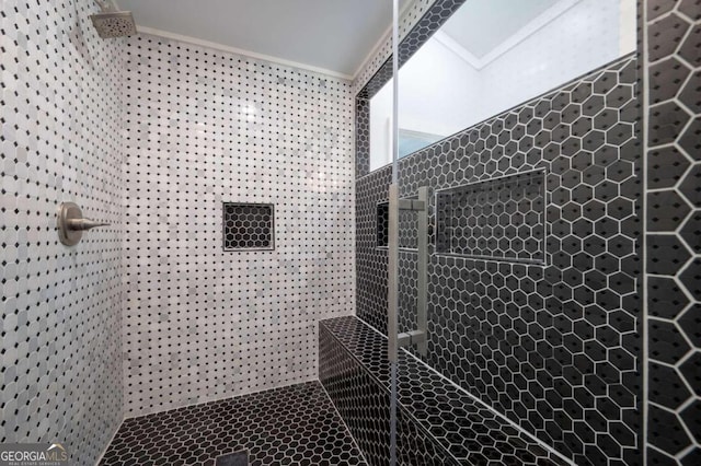 bathroom with tiled shower and crown molding