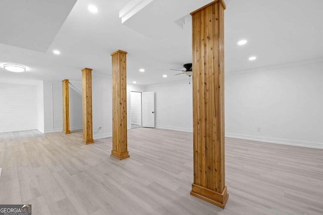 basement featuring ceiling fan, crown molding, and light wood-type flooring