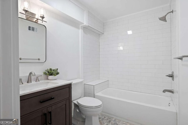 full bathroom featuring vanity, tiled shower / bath, and toilet