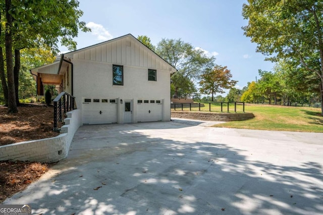 view of property exterior with fence, concrete driveway, and an attached garage