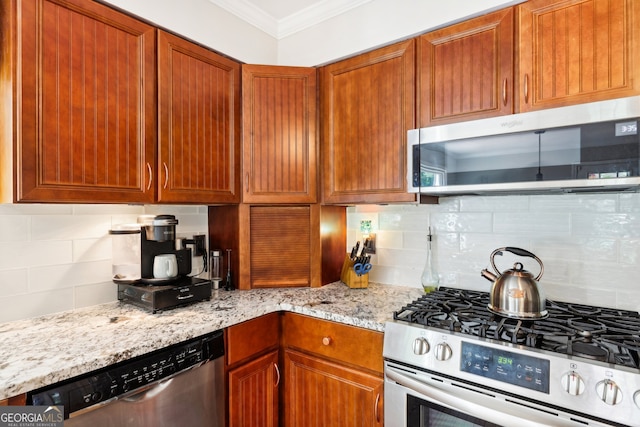 kitchen featuring ornamental molding, light stone countertops, stainless steel appliances, and backsplash