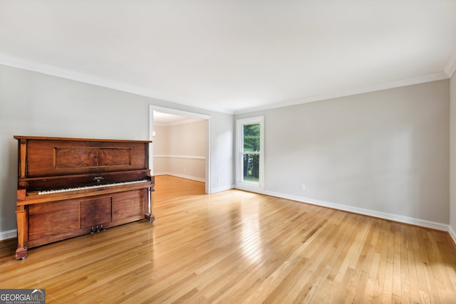 interior space featuring crown molding and light wood-type flooring