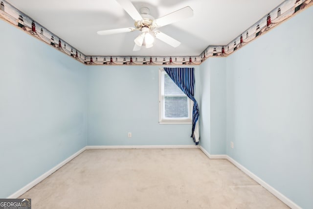 spare room featuring carpet and ceiling fan