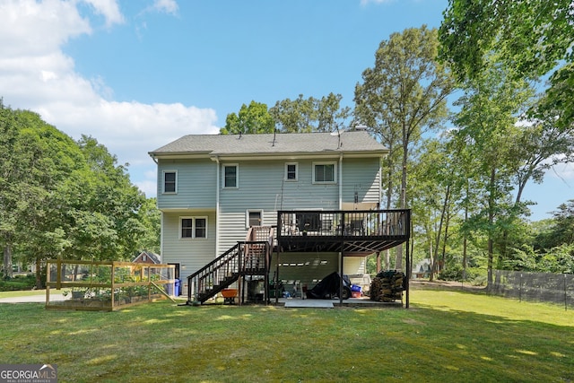 rear view of house with a deck and a lawn