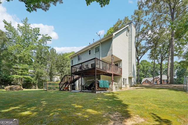 back of house featuring a yard and a wooden deck