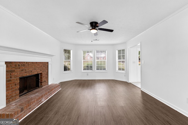 unfurnished living room with crown molding, a brick fireplace, and dark hardwood / wood-style flooring