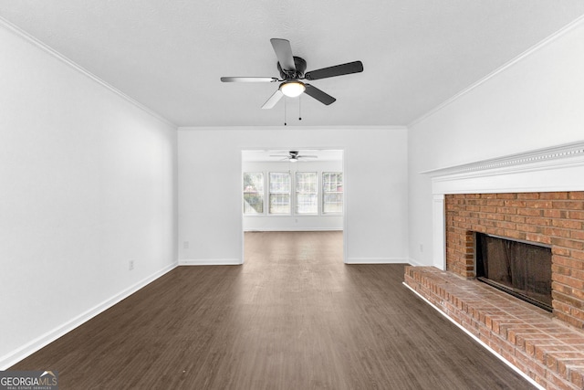 unfurnished living room featuring ceiling fan, a fireplace, ornamental molding, and dark hardwood / wood-style floors