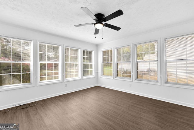 unfurnished sunroom featuring ceiling fan