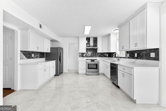 kitchen featuring white cabinetry, stainless steel appliances, and wall chimney range hood