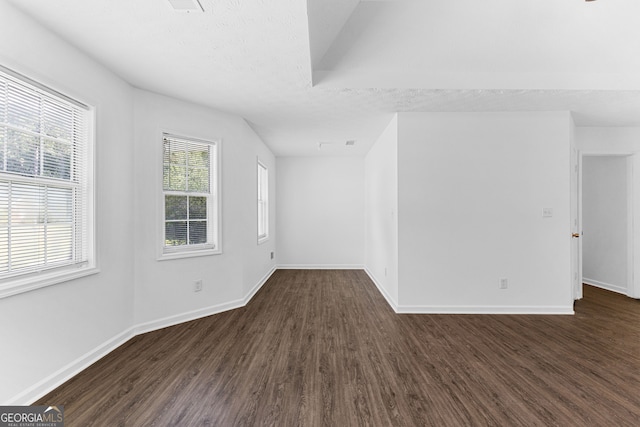 bonus room with a textured ceiling and dark hardwood / wood-style flooring