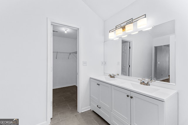 bathroom featuring vanity, lofted ceiling, and tile patterned flooring