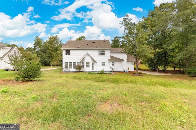 back of property featuring a lawn