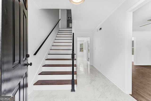 staircase with crown molding and hardwood / wood-style flooring