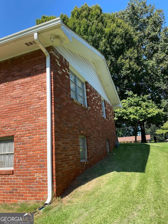 view of side of home featuring a yard