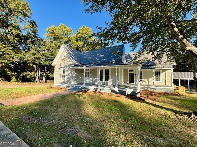 view of front of property with a front yard and a porch