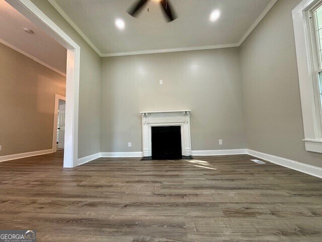 17843 Main St, Woodbury, GA 30293 - unfurnished living room featuring crown molding and dark hardwood / wood-style floors