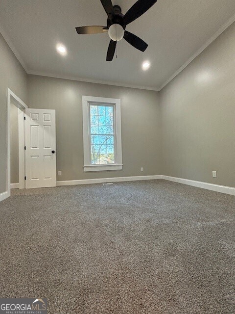 17843 Main St, Woodbury, GA 30293 - carpeted empty room featuring crown molding and ceiling fan