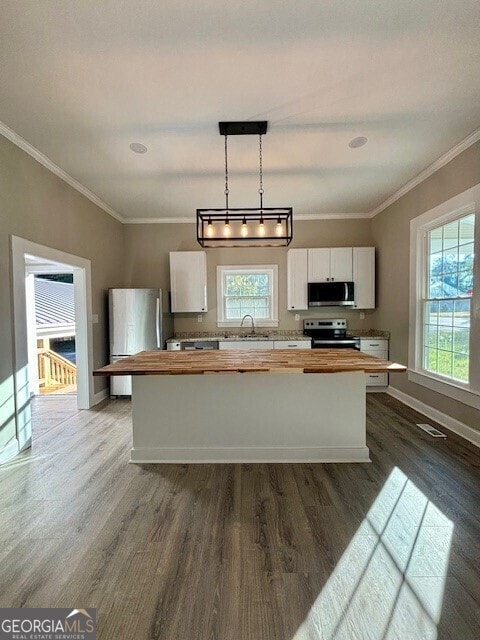 17843 Main St, Woodbury, GA 30293 - kitchen featuring appliances with stainless steel finishes, white cabinetry, wood counters, dark hardwood / wood-style floors, and pendant lighting