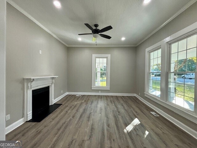 17843 Main St, Woodbury, GA 30293 - unfurnished living room with crown molding, a healthy amount of sunlight, and dark hardwood / wood-style floors