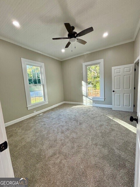 17843 Main St, Woodbury, GA 30293 - carpeted empty room featuring ornamental molding and ceiling fan