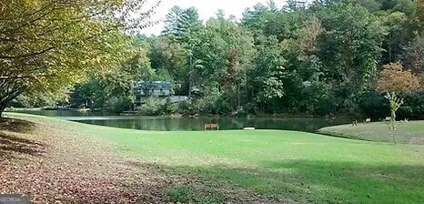 view of home's community featuring a yard and a water view