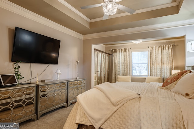 carpeted bedroom featuring ceiling fan, a raised ceiling, and ornamental molding