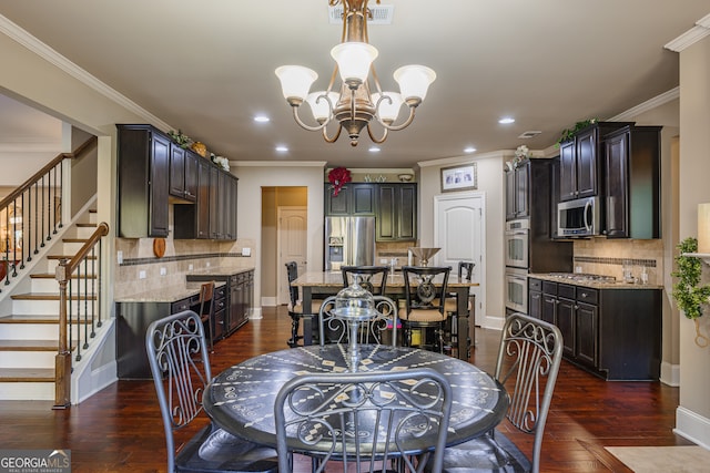 dining room featuring an inviting chandelier, crown molding, and dark hardwood / wood-style flooring