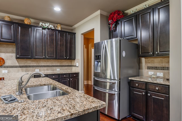 kitchen featuring sink, backsplash, stainless steel fridge, dark wood-type flooring, and ornamental molding