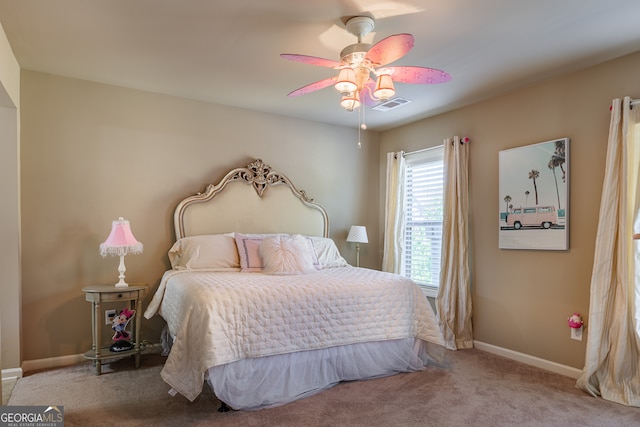 bedroom featuring light colored carpet and ceiling fan