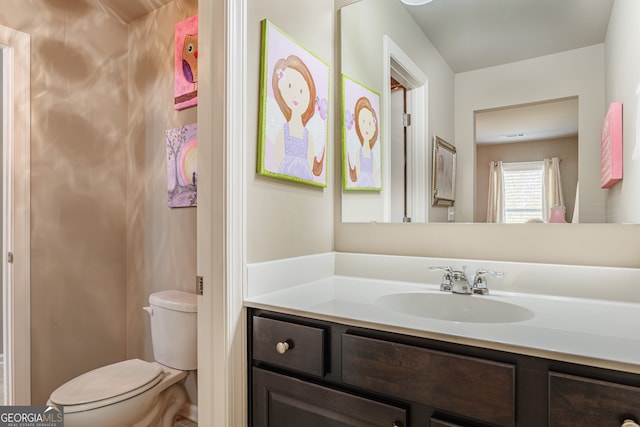 bathroom with toilet and vanity