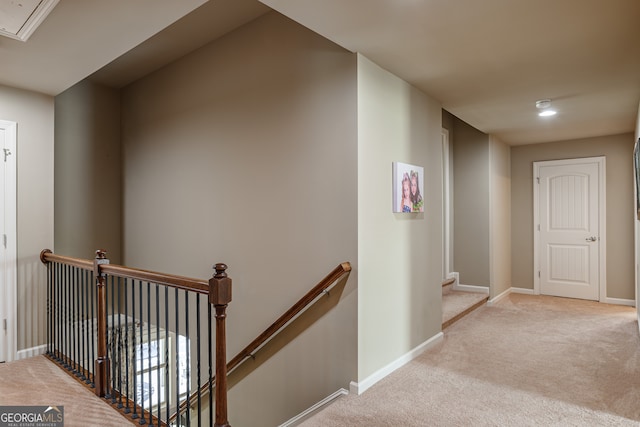 hallway featuring light colored carpet