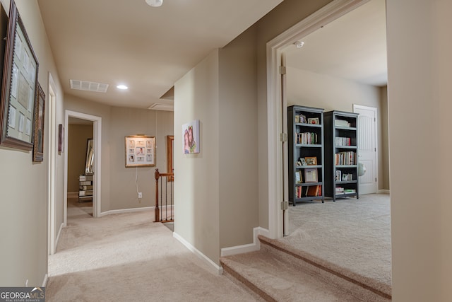 hall featuring light colored carpet