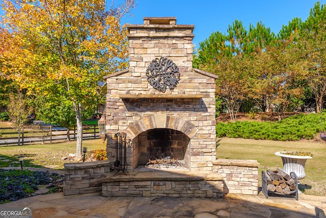 view of patio featuring an outdoor stone fireplace