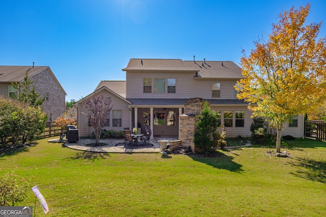 back of house with a patio and a yard