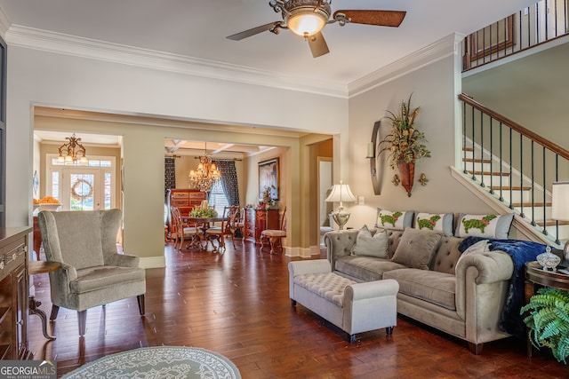 living room with crown molding, dark hardwood / wood-style floors, and ceiling fan with notable chandelier