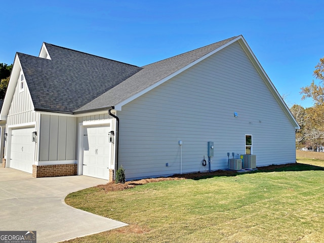 view of home's exterior featuring a garage, cooling unit, and a lawn