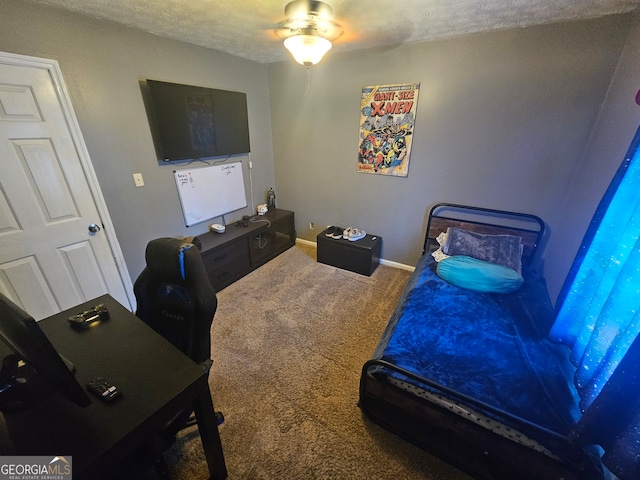 bedroom featuring ceiling fan, carpet flooring, and a textured ceiling