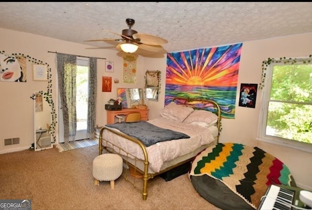 bedroom with carpet floors, a textured ceiling, and ceiling fan