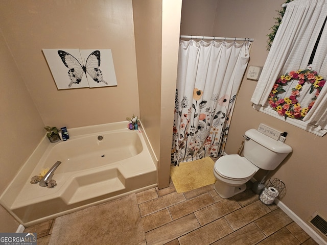 bathroom featuring toilet and a tub