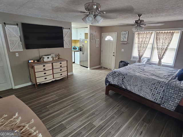 bedroom featuring ceiling fan, wood-type flooring, a textured ceiling, and stainless steel fridge