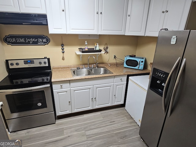 kitchen featuring washer / clothes dryer, stainless steel appliances, sink, white cabinetry, and light hardwood / wood-style floors