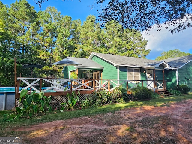 back of house featuring a deck