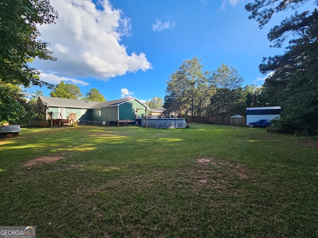 view of yard featuring a swimming pool side deck