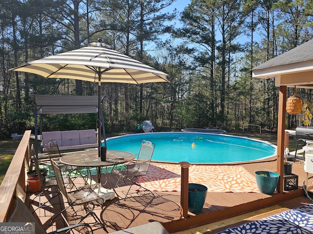 view of swimming pool with a wooden deck