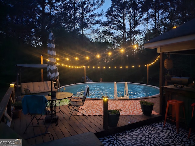 view of pool with a wooden deck