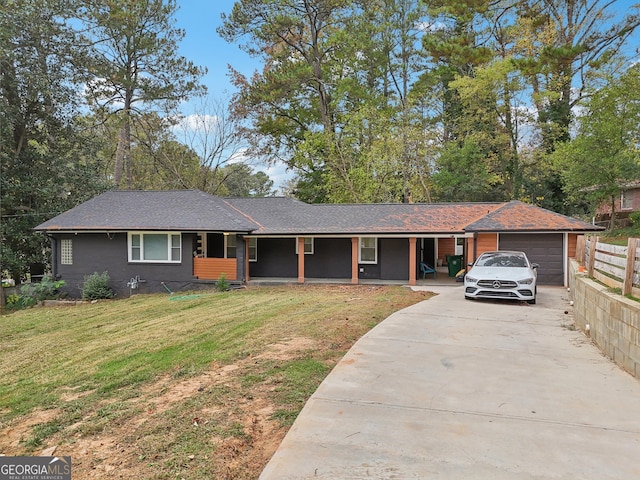 ranch-style house with a garage and a front lawn