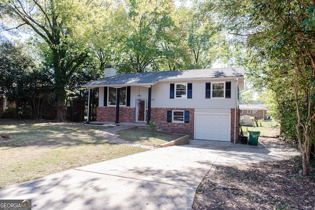 view of front of property with covered porch, a garage, and a front yard